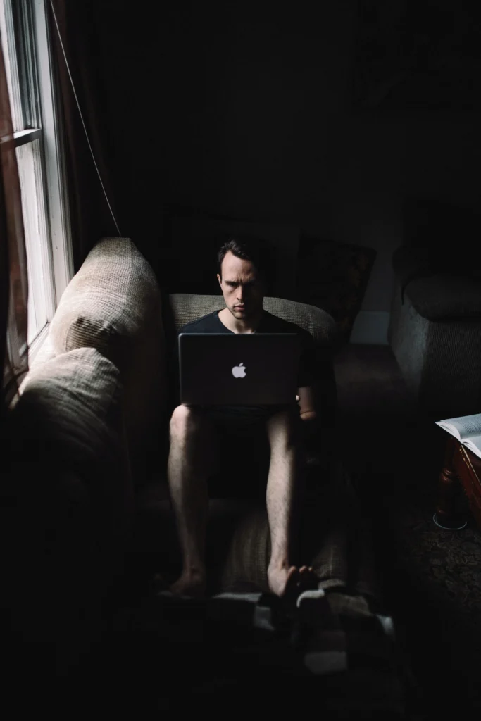 A man coding on his couch